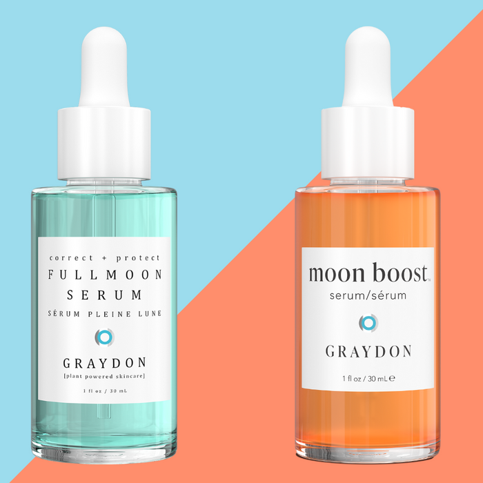 Bottle of Graydon Skincare Fullmoon Serum and Moon Boost Serum on a blue and orange background.