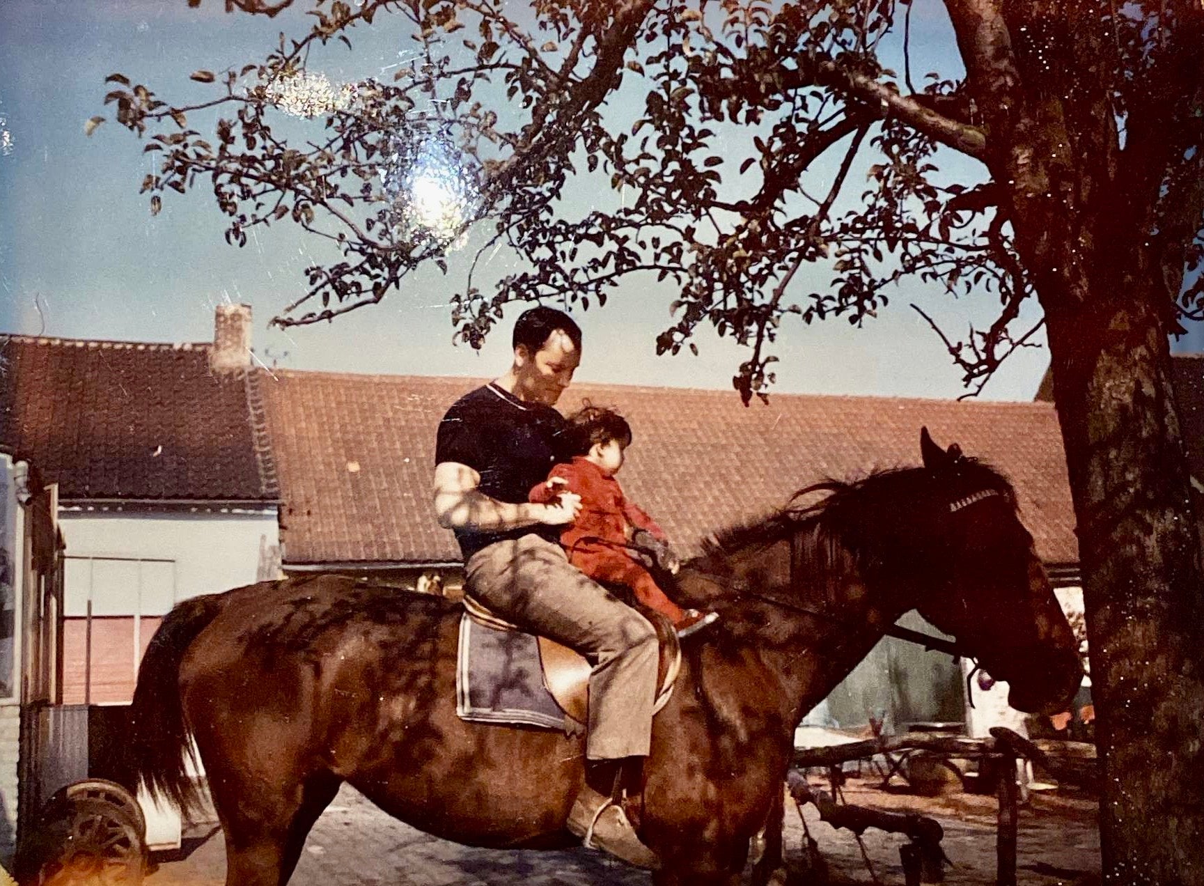 Graydon and her dad on a horse when she was a child