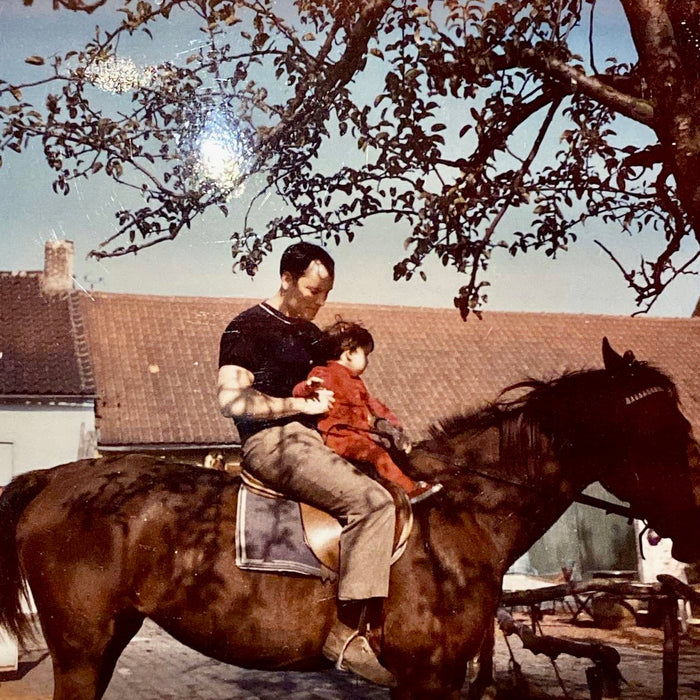 Graydon and her dad on a horse when she was a child