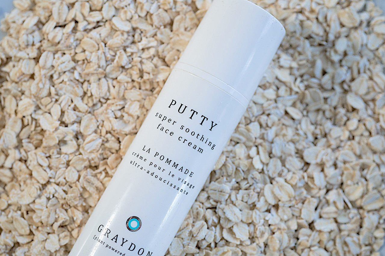 A soothing moisturizer for dry skin in white packaging on a bed of oats